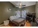 This bedroom features a ceiling fan, hardwood floors, and themed Star Wars curtains at 1109 E San Pedro Ave, Gilbert, AZ 85234
