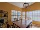 Dining room with large windows, a traditional wood dining table, and a rustic chandelier at 1109 E San Pedro Ave, Gilbert, AZ 85234
