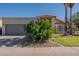 Home featuring a two-car garage and desert landscaping at 1109 E San Pedro Ave, Gilbert, AZ 85234