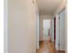 Hallway with hardwood floors, white walls, and multiple doorways leading to other rooms at 1109 E San Pedro Ave, Gilbert, AZ 85234