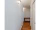 Hallway with hardwood floors, white walls, and a small table against the wall at 1109 E San Pedro Ave, Gilbert, AZ 85234