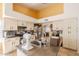 Bright eat-in kitchen featuring a functional island with white cabinets and stainless steel appliances at 1109 E San Pedro Ave, Gilbert, AZ 85234