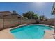Backyard pool and patio with a concrete surround and lush surroundings at 1109 E San Pedro Ave, Gilbert, AZ 85234