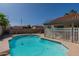 Backyard pool with a concrete surround, white fence, and mature landscaping at 1109 E San Pedro Ave, Gilbert, AZ 85234