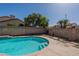 Backyard pool with concrete surround, block fence, and mature landscaping at 1109 E San Pedro Ave, Gilbert, AZ 85234