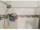 A close-up of a walk-in shower featuring white subway tile and a rainfall shower head at 1109 E San Pedro Ave, Gilbert, AZ 85234