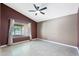 Bedroom featuring a ceiling fan, tile floors, neutral walls, and natural light from the window at 1120 N Val Vista Dr # 110, Gilbert, AZ 85234