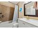 Inviting bathroom with tub-shower combo, updated vanity, and decorative mirror at 1126 W Elliot Rd # 1066, Chandler, AZ 85224