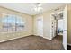 Comfortable bedroom featuring a bright window, neutral walls and carpet, and a ceiling fan at 1126 W Elliot Rd # 1066, Chandler, AZ 85224