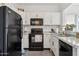 Well-lit kitchen with black appliances, white cabinetry, and granite countertops at 1126 W Elliot Rd # 1066, Chandler, AZ 85224