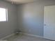 Simple bedroom featuring tile floors, a window for natural light, and a white door at 1130 E Butler Dr # B4, Phoenix, AZ 85020
