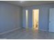 Spacious bedroom with tiled flooring, white trim, and adjoining bathroom and closet at 1130 E Butler Dr # B4, Phoenix, AZ 85020