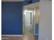 Hallway with tile flooring, a blue wall, and several doors leading to other rooms at 1130 E Butler Dr # B4, Phoenix, AZ 85020