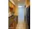 Bright kitchen features wood cabinets, stainless steel sink, and black refrigerator at 1130 E Butler Dr # B4, Phoenix, AZ 85020