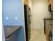 Compact kitchen with black refrigerator, wood cabinets, tiled floors and granite countertops at 1130 E Butler Dr # B4, Phoenix, AZ 85020