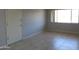 This living room boasts tile floors, a neutral wall color, a front door, and a bright window at 1130 E Butler Dr # B4, Phoenix, AZ 85020