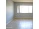 Sun-filled living room featuring neutral paint, tile flooring and bright light from large window at 1130 E Butler Dr # B4, Phoenix, AZ 85020