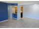 Spacious living room leading into kitchen with bar, neutral wall color, and tile floors at 1130 E Butler Dr # B4, Phoenix, AZ 85020