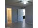 Open main bedroom with ceiling fan, tile floors, and ensuite bathroom at 1130 E Butler Dr # B4, Phoenix, AZ 85020