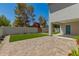 A lush backyard with artificial turf, privacy wall, desert landscaping, and a covered patio at 1131 E Bishop Dr, Tempe, AZ 85282