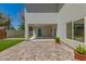 The backyard covered patio has brick pavers with a vibrant blue door, and views of manicured lawn at 1131 E Bishop Dr, Tempe, AZ 85282