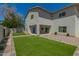 Spacious backyard features a covered patio, lush artificial lawn, and low maintenance landscaping at 1131 E Bishop Dr, Tempe, AZ 85282