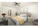Relaxing bedroom features a ceiling fan, wood floors, and ensuite bathroom access at 1131 E Bishop Dr, Tempe, AZ 85282