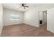 Large bonus room with wood floors, a window, and access to the stairs at 1131 E Bishop Dr, Tempe, AZ 85282