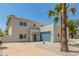 Contemporary home showcasing clean lines, a blue garage door, desert landscaping, and palm trees at 1131 E Bishop Dr, Tempe, AZ 85282