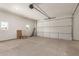 Spacious two-car garage with high ceilings, cement flooring, and natural light from side windows at 1131 E Bishop Dr, Tempe, AZ 85282