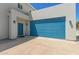 Exterior view of a modern home, highlighting the blue garage door and welcoming entrance at 1131 E Bishop Dr, Tempe, AZ 85282