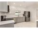 Bright kitchen features white cabinets, stainless steel appliances, and quartz countertops at 1131 E Bishop Dr, Tempe, AZ 85282