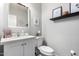 Traditional half bathroom with a white vanity, framed mirror, and decorative accents at 1324 S Banning St, Gilbert, AZ 85296