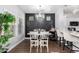 Stylish dining room features a modern chandelier, decorative wall paneling, and a chic bar area, perfect for entertaining guests at 1324 S Banning St, Gilbert, AZ 85296