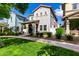 Charming two-story home features a covered porch, landscaped front yard, and well-maintained lawn, creating inviting curb appeal at 1324 S Banning St, Gilbert, AZ 85296