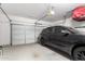 Spacious garage featuring a car with epoxy flooring and an automatic door opener at 1324 S Banning St, Gilbert, AZ 85296
