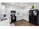 Modern kitchen features white cabinetry, black appliances, and updated countertops, creating a clean and functional cooking space at 1324 S Banning St, Gilbert, AZ 85296