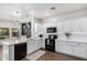 Modern kitchen features white cabinetry, black appliances, and updated countertops, creating a clean and functional cooking space at 1324 S Banning St, Gilbert, AZ 85296