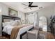 Comfortable main bedroom with plush bedding, hardwood floors, soft lighting, and a sitting bench at 1324 S Banning St, Gilbert, AZ 85296