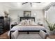 Bright main bedroom featuring neutral walls, hardwood floors, decorative lighting, and plush bedding at 1324 S Banning St, Gilbert, AZ 85296