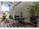 Cozy patio area with table and chairs, shaded by a pergola and surrounded by greenery at 1324 S Banning St, Gilbert, AZ 85296