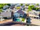 Backyard boasts a sparkling pool, lush lawn, and a covered patio, creating an ideal space for outdoor living and entertaining guests at 13625 W Peck Ct, Litchfield Park, AZ 85340