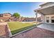 This backyard offers a well-manicured lawn and refreshing pool perfect for relaxation and entertainment at 13625 W Peck Ct, Litchfield Park, AZ 85340