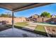 This cozy backyard features a covered patio area, a well-manicured lawn and a refreshing pool at 13625 W Peck Ct, Litchfield Park, AZ 85340