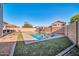 Spacious backyard with a pool and covered patio, perfect for entertaining at 13625 W Peck Ct, Litchfield Park, AZ 85340