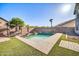 Serene backyard pool surrounded by lush artificial turf and a swing at 13625 W Peck Ct, Litchfield Park, AZ 85340