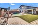Backyard features a sparkling pool, swing, and paved patio area at 13625 W Peck Ct, Litchfield Park, AZ 85340