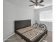 Bright bedroom showcases a sleek bed frame, ceiling fan, and natural light at 13625 W Peck Ct, Litchfield Park, AZ 85340