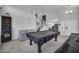 Spacious game room with pool table, dart board, and staircase, perfect for entertaining guests at 13625 W Peck Ct, Litchfield Park, AZ 85340