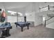 Large game room with a vaulted ceiling, pool tables, tv, and plenty of space for recreation at 13625 W Peck Ct, Litchfield Park, AZ 85340
